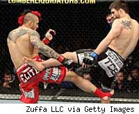 Dan Hardy and Carlos Condit exchange kicks at UFC 120 on Saturday in London.
